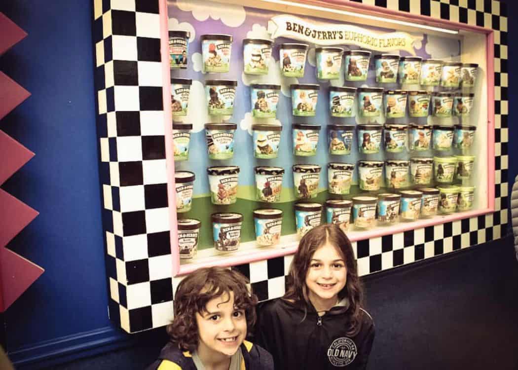 Ben and Jerrys Factory - Kids smiling in front of wall of ice cream